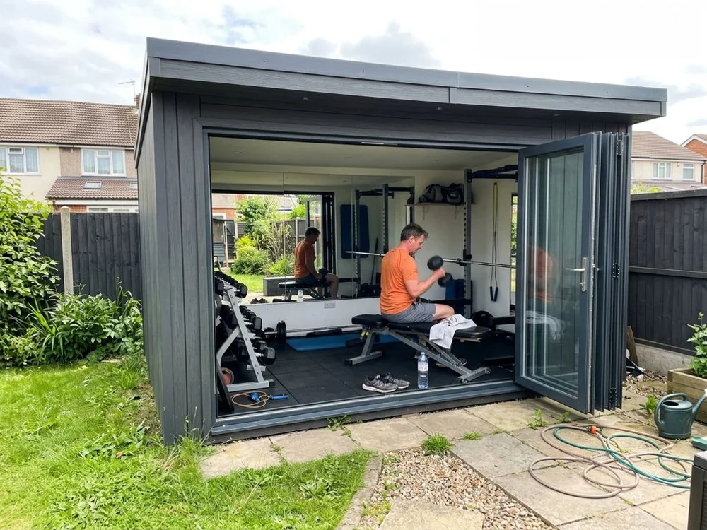 Insulated garden gym with mirrors and bifold doors in Luton